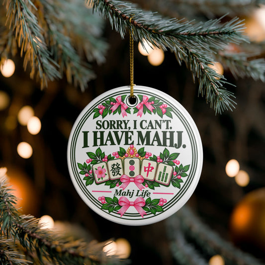 Sorry I Can't I Have Mahj ceramic Christmas ornament hanging on a tree with pink bows and mahjong tiles